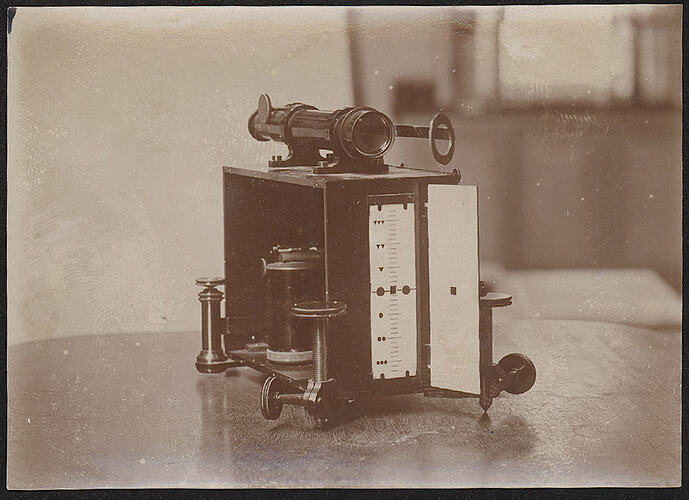 Scientific apparatus, with telescope, on table.