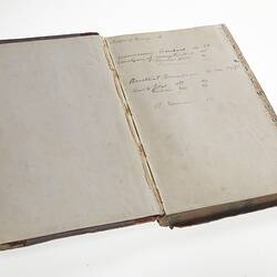 Open book. The left page is blank, the right side has handwritten cursive text in ink.