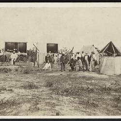 Men with telescopes and tents.