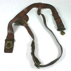 Brown leather belt with gpld coloured buckles.