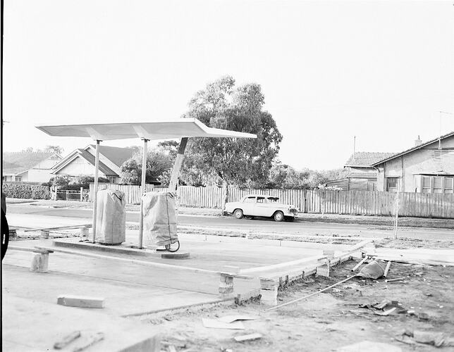 Monochrome photograph of a petrol station.