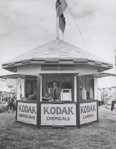 Kodak staff member in outdoor booth.