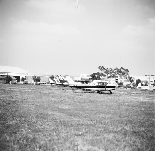 Monochrome image of aircraft on a field.