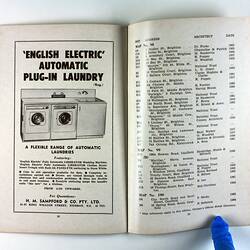 Open booklet showing washing machine advertisement with photo