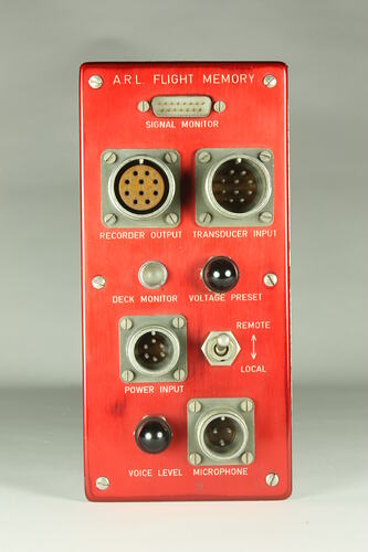 Red control panel with knobs and dials.