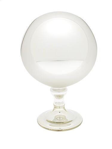 Mirrored glass globe on glass stand.