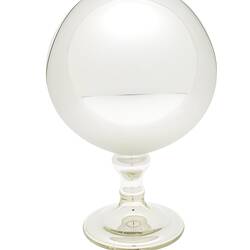 Mirrored glass globe on glass stand.