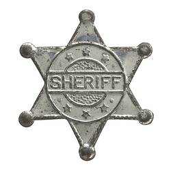 Toy star-shaped silver metal sheriff badge.