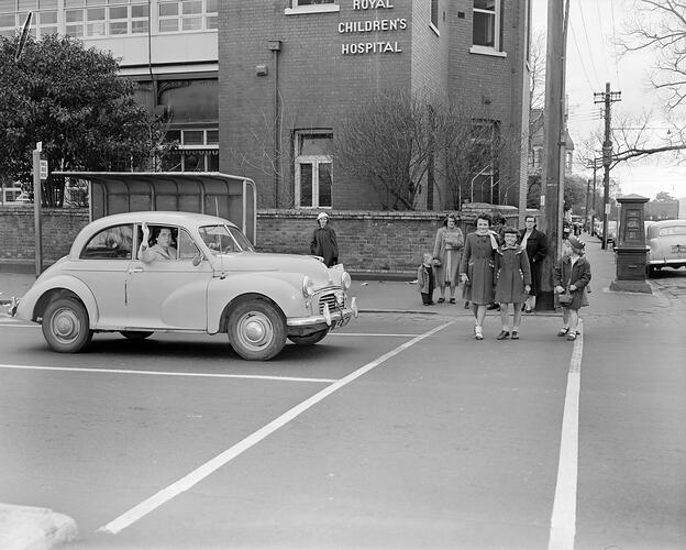 Woman in Motor Car at Pedestrian Crossing, Carlton, Victoria, Jul 1958