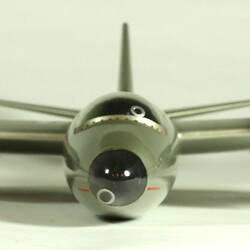 Silver model aeroplane. Front view.