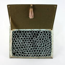 Open box with scrolls from above.