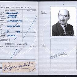 Open passport with two white pages with printed pattern. Printed and handwritten text. Photo of male.