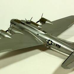 Silver model aeroplane. Three quarter back left view.
