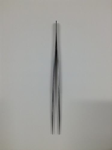 Stainless steel tweezers, with grooves placed for ease of grip.