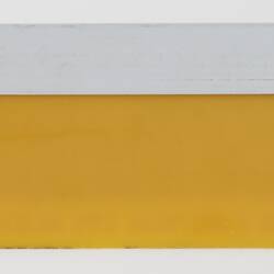 Back of yellow plastic measuring ruler.