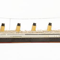 Cardboard model of passenger steamship with four funnels.