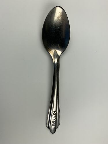 Metal spoon with Kodak on handle.