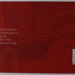 Reverse of red rectangular card with black and white printed text. Barcode lower right.