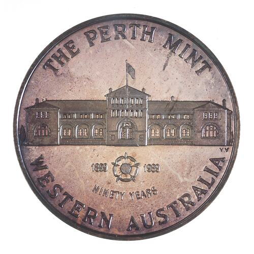Round medal with Perth Mint building with flag flying, below, a rose with dates.