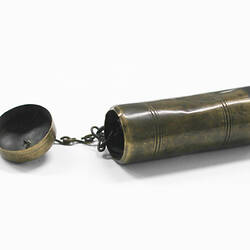 Cylindrical brass tinder box with lid on chain.