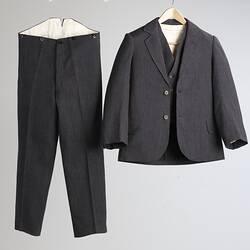 Black and white woollen three piece suit. Trousers, jacket and waistcoat.