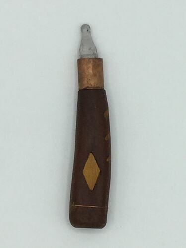 Knife with carved dark wooden handle and small blade. Lighter wooden diamond in handle centre.