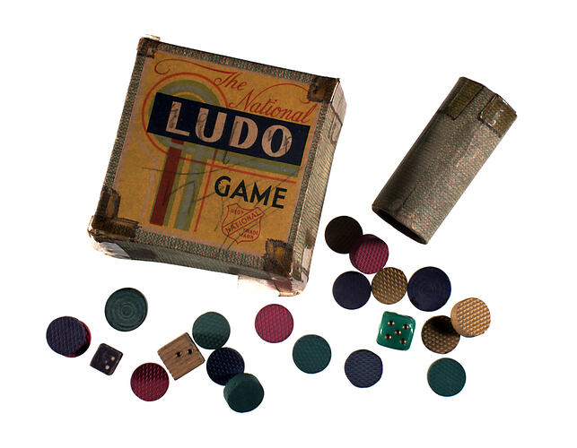 Game box with pieces scattered around.