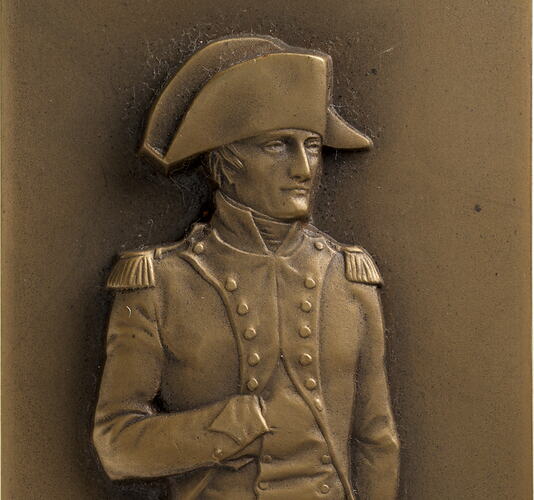 Male three quarter pose facing right, wearing military uniform. Right hand inserted into jacket.