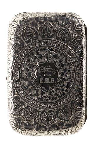 Heavily engraved silver cigarette case with central text. Rectangular with rounded corners.