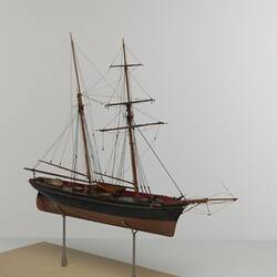 Black and brown sailing ship model. Two masts. Right three-quarter profile.