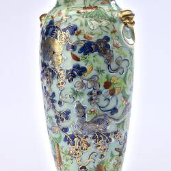 Porcelain vase with all-over pattern of birds, flowers, butterflies and two rats climbing amongst branches.