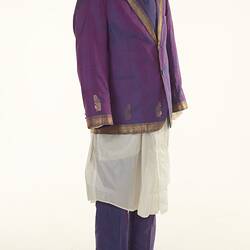 Purple sari two-piece suit and matching tie, long off-white shirt. Gold detail on jacket edging.