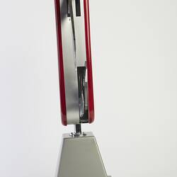 Model of muti-tool on stand. Red handle with all tools out. Side view.
