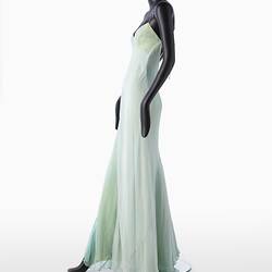 Full length pale green silk evening slip dress. Sleeveless. Flared/fishtail skirt. Left profile.