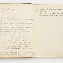 Open book with off white ruled pages. Handwritten text.