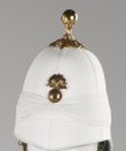 White helmet with gold front central badge. Gold piece on crown.
