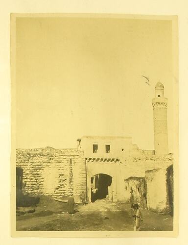 Exterior of arched gateway and minaret in Mosul.
