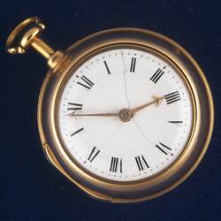 Gentleman's pocket watch with white face, roman numerals and gold hands.