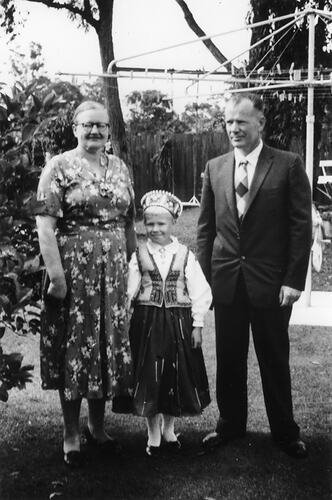Apinis family in backyard, 1957