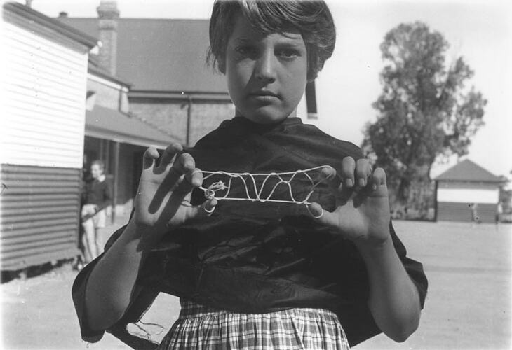Photograph - Girl Playing 'Bridge' or 'French Lace' String Game, Dorothy Howard Tour, 1954-1955