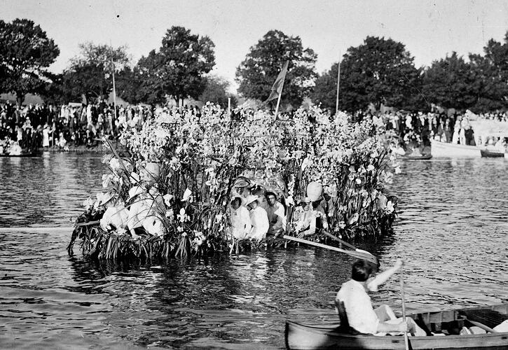Decorated boat on a river full of men and women.