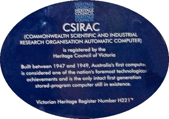 Blue oval plaque with white text.
