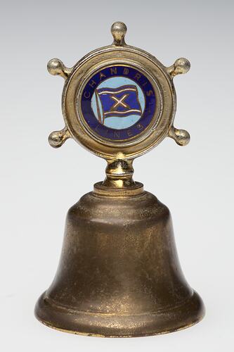 Brass bell with inlaid decoration on handle.