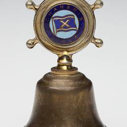 Brass bell with inlaid decoration on handle.