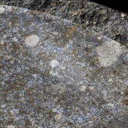 Close-up of portion of meteorite specimen.