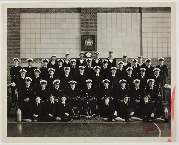 Group portrait of men and woman in Navy uniform.