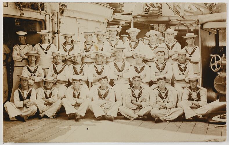 Group portrait of seamen on a ship deck.