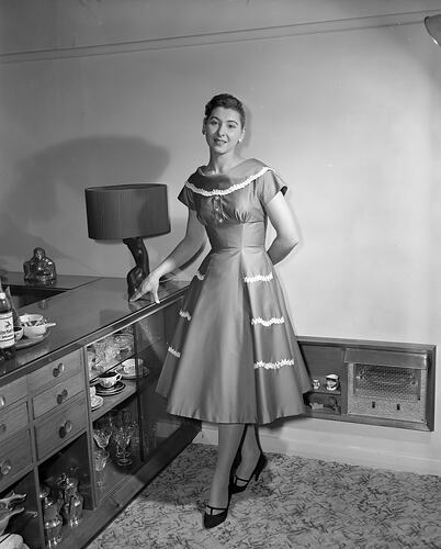 Ladies Fashion, Model Standing by a Cabinet, Victoria, 12 May 1959