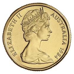 Round gold coin with profile of female bust.