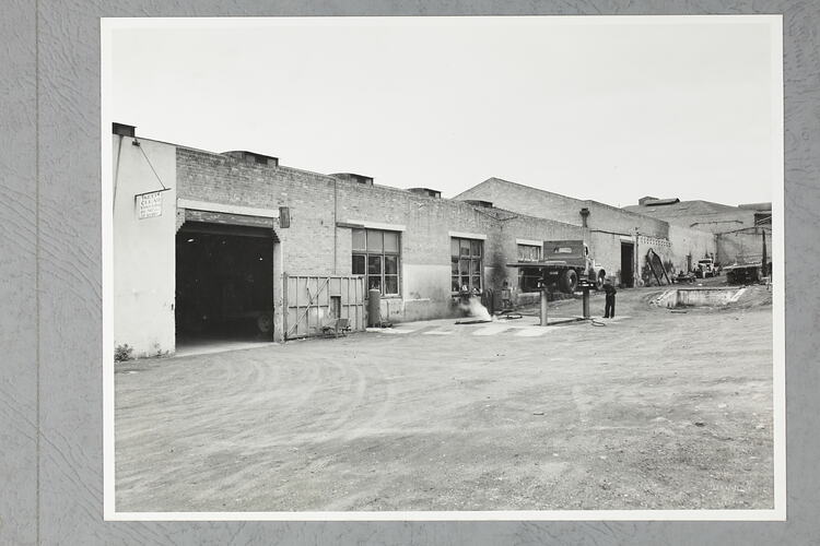 Monochrome photograph of a showroom exterior.